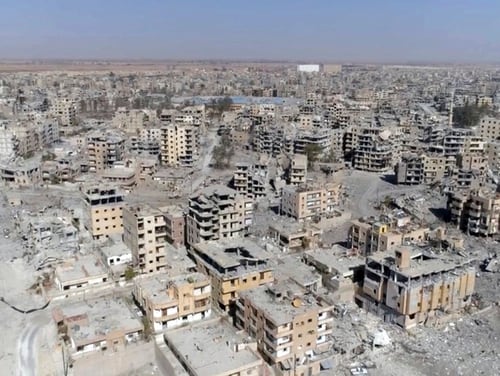 This Oct. 19, 2017, image from drone video, shows damaged buildings in Raqqa, Syria, two days after Syrian Democratic Forces said military operations to oust the Islamic State group ended. A U.S. military official says that the American-backed Syrian Democratic Forces in January 2018 captured two notorious British members of an Islamic State insurgent cell commonly dubbed “The Beatles” and known for beheading hostages. (Gabriel Chaim/AP)