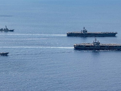 The USS Ronald Reagan (CVN 76) and USS Nimitz (CVN 68) Carrier Strike Groups (CSGs) steam in formation on July 6, 2020, in the South China Sea. (MC3 Jason Tarleton/Navy)