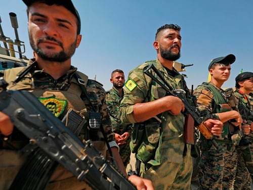 Members of the People's Protection Units (YPG), part of the of the Syrian Democratic Forces (SDF), gather in the town of Shadadi, about 60 kilometers (37 miles) south of the northeastern Syrian city of Hassakeh, on Sept. 11, 2018. (Delil Souleiman/AFP via Getty Images)
