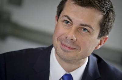 In this April 29, 2019, file photo, then Democratic presidential candidate Mayor Pete Buttigieg, from South Bend, Ind., listens during a lunch meeting with civil rights leader Rev. Al Sharpton at Sylvia's Restaurant in Harlem neighborhood of New York.