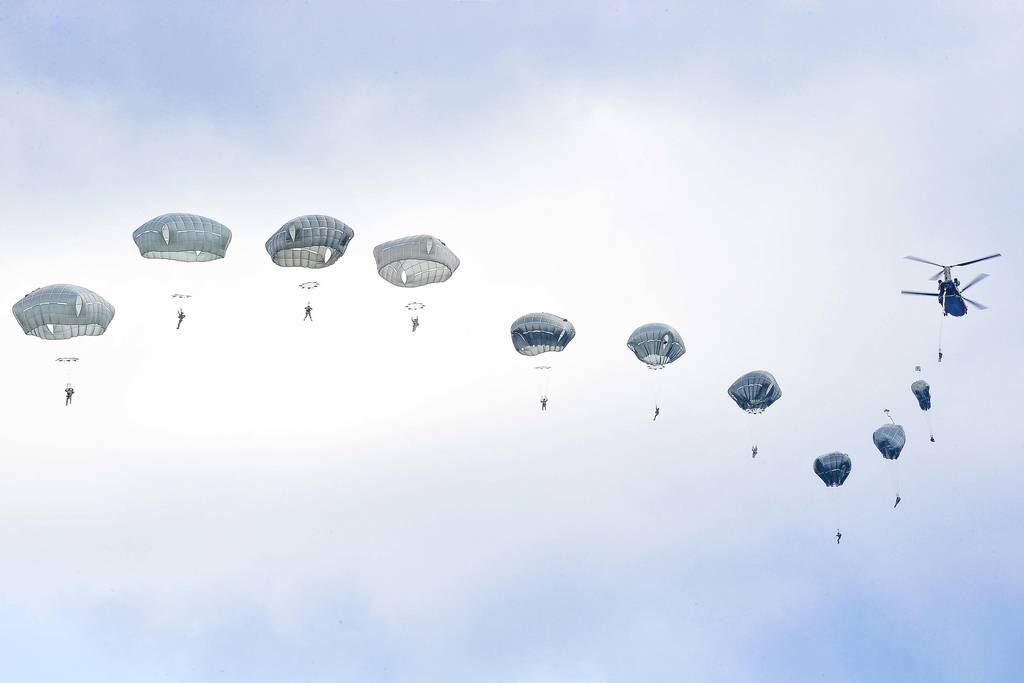 U.S. Army paratroopers execute an airborne proficiency jump from a CH-47 Chinook helicopter onto Bunker Drop Zone in Grafenwoehr Training Area, Germany, Aug. 14, 2019.