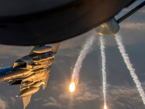An Air Force F-15 Eagle deploys flares while departing from a KC-135 Stratotanker assigned to the 340th Expeditionary Air Refueling Squadron during a refueling mission above Iraq March 16. Few full squadrons deploy as a fighting formation, but must be prepared to do so, Air Force leaders say. (Tech. Sgt. Paul Labbe/Air Force)