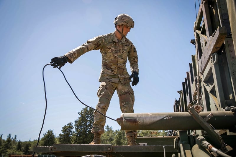 U.S. Army Sgt. Kevin Lanehart grounds the Guided Missile Transporter in case of an electrical surge, May 18, 2021, at a Croatian air force base in Zadar. (Sgt. Joshua Oh/U.S. Army)