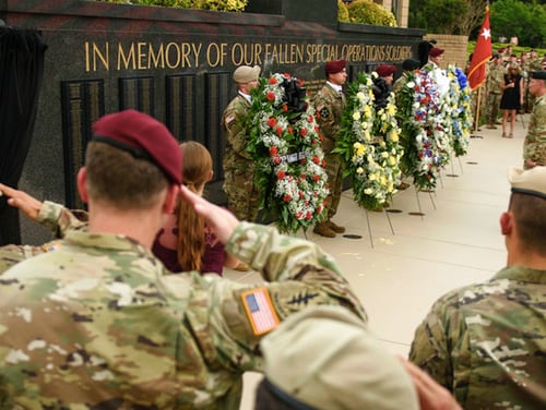 Soldiers at Fort Bragg, N.C., salute at a memorial ceremony for U.S. Army Special Operations Command soldiers. The names of four soldiers killed during an ambush in Niger in 2017 were added to the memorial wall at Fort Bragg. Now the Defense Department says it will cut back on forces in Africa. (Andrew Craft /The Fayetteville Observer via AP)