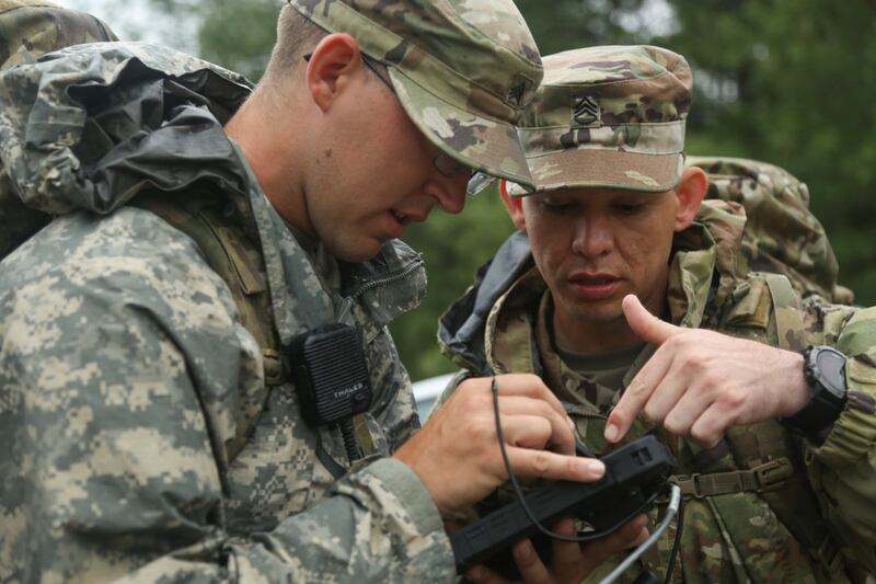 Sgt. David Hendrixson, left, and Staff Sgt. Jacob Rascon, both with 3rd Brigade Combat Team, 101st Airborne Division (Air Assault), analyze prototyped cyber field equipment during Cyber Quest 2019. (Spc. TaMaya Eberhart/Army)