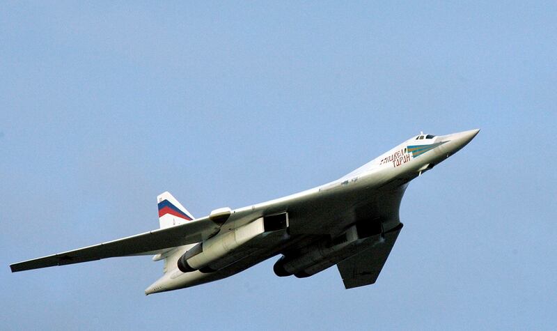 In this Aug. 16, 2005, file photo, a supersonic Tu-160 strategic bomber with Russian President Vladimir Putin aboard flies above an airfield near the northern city of Murmansk. The Russian military says two of its nuclear-capable strategic bombers have arrived in Venezuela, a deployment that comes amid soaring Russia-U.S. tensions. (Alexei Panov/Sputnik, Kremlin Pool Photo via AP)