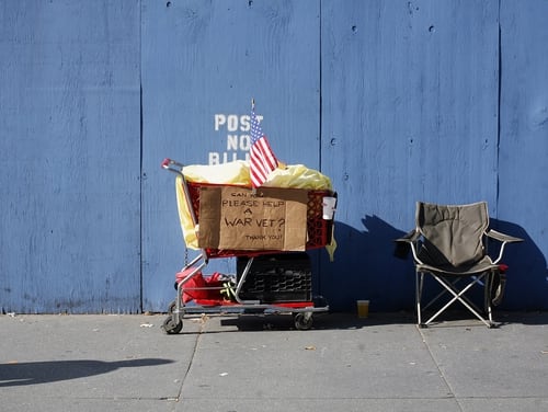 The grocery cart and chair of a person experiencing homelessness is shown along Fifth Avenue during New York City's annual Veterans Day parade in 2006. (Michael Nagle/Getty Images)