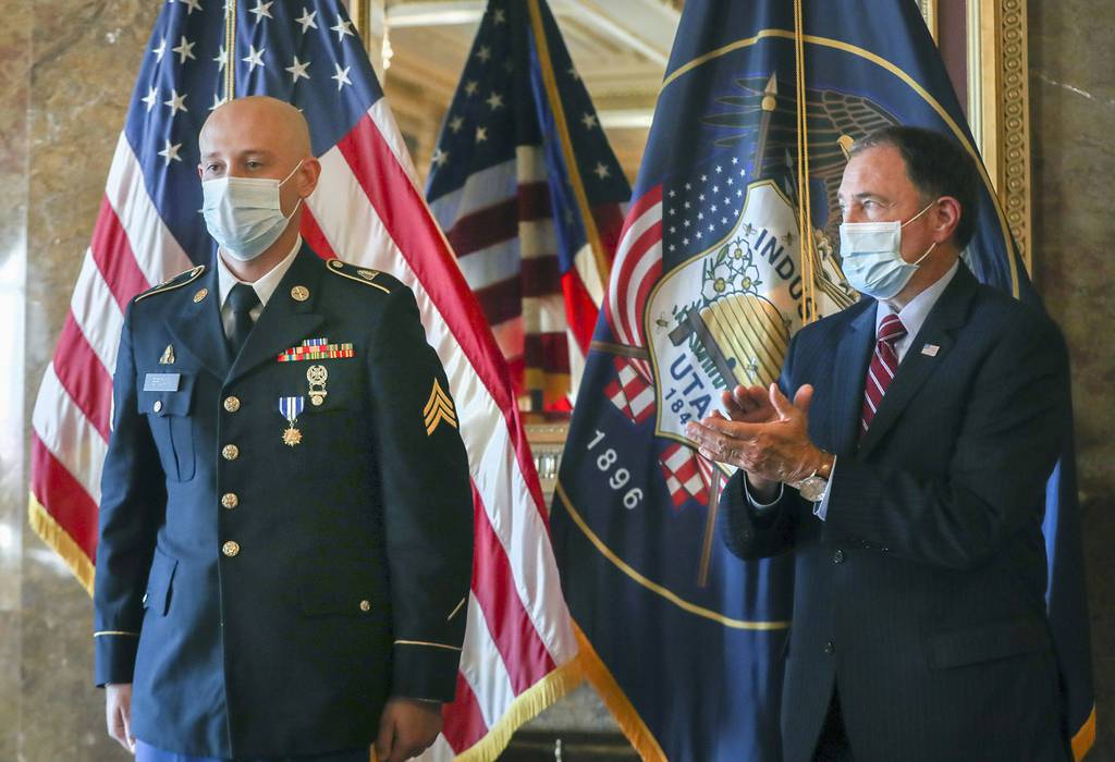 Gov. Gary Herbert applauds for Sgt. Chasen Brown, a service member of the Utah National Guard, after presenting him with the Utah Medal of Valor in the Gold Room at the Utah State Capitol on Tuesday, Sept. 1, 2020, in Salt Lake City.