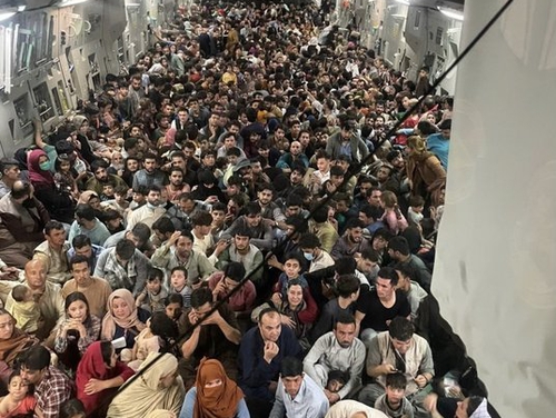 U.S. Air Force confirmed a stunning logistical feat, saying that more than 800 Afghan citizens were aboard a C-17 Globemaster III as it left Hamid Karzai International Airport on Sunday. (Air Force photo).
