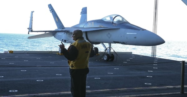A sailor makes a call to raise the lifeline of an aircraft elevator last month aboard the carrier Gerald R. Ford. (U.S. Navy photo)