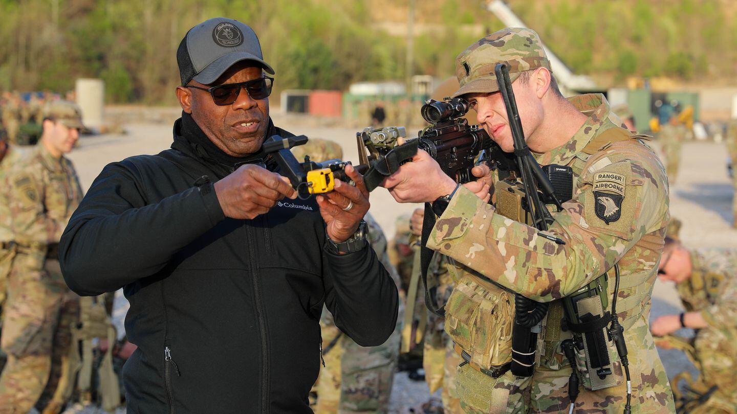 A soldier with the 506th Infantry Regiment, 3rd Brigade Combat Team, 101st Airborne Division (Air Assault), receives instructions on Saab's Force-on-Force Training System-Next from James McArthur, operations manager for Saab. (Spc. Robert Faison/Army)