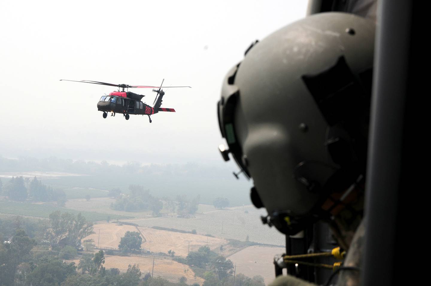 U.S. Army Sgt. Jaime Martinez Jr., a crew chief with 1st Assault Helicopter Battalion, 140th Aviation Regiment, watches his fellow unit members follow him back to refuel, Aug. 23, 2020, in Healdsburg, Calif.