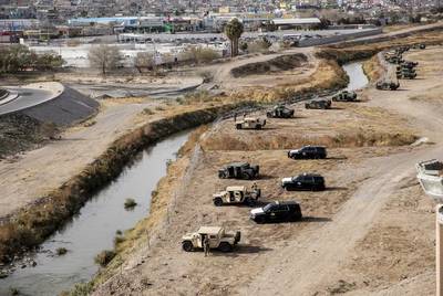Texas National Guard members and DPS officers take positions along the Rio Grande in El Paso to help patrol the border between the U.S. and Mexico December 2022.