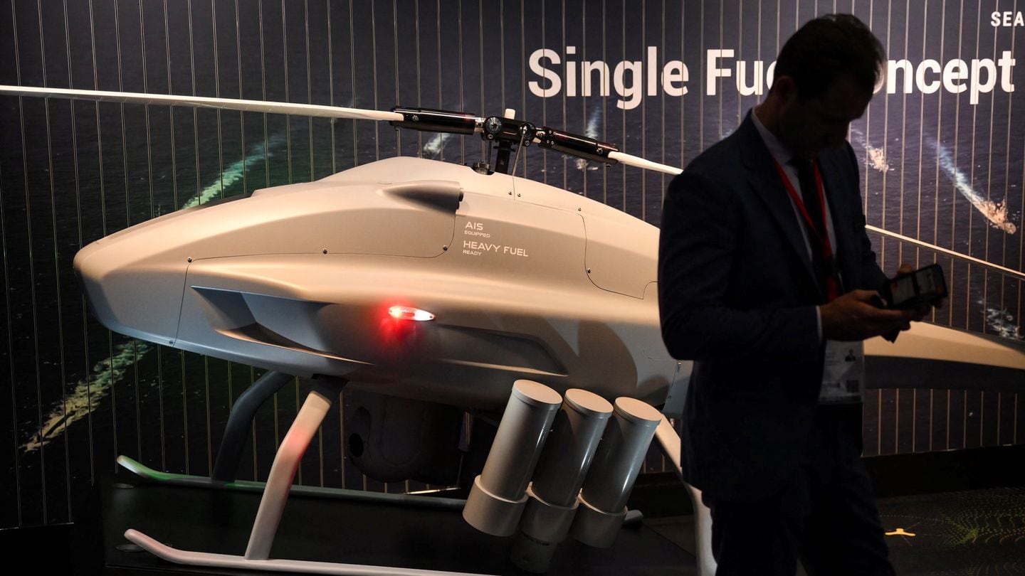 A visitor stands in front of an unmanned helicopter during the DSEI fair at the ExCeL center on Sept. 12, 2023. (Daniel Leal/AFP via Getty Images)