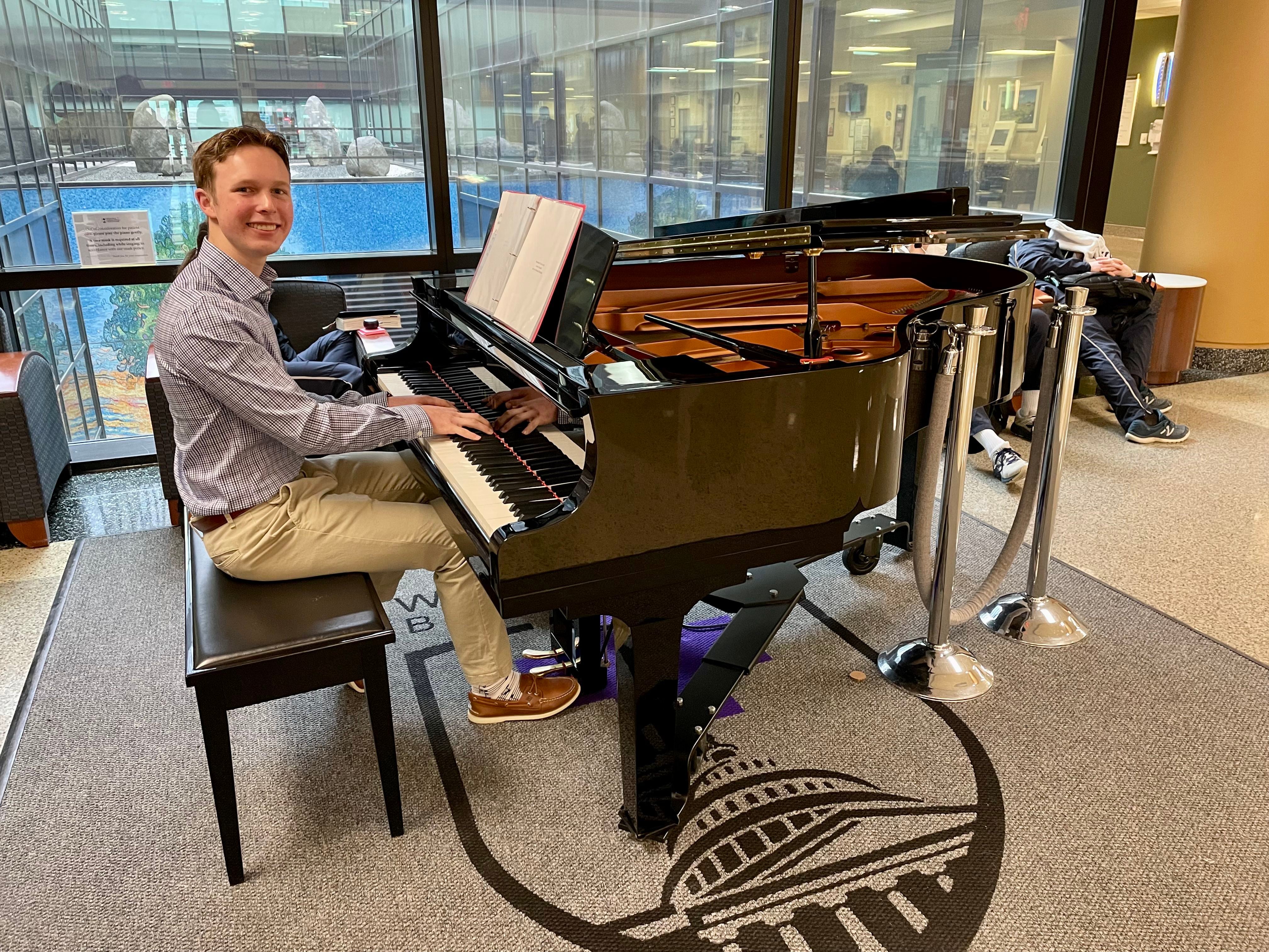Mitchell Matella volunteers to play the piano for patients, staff and visitors at Walter Reed National Military Medical Center. (Courtesy  of Mitchell Matella)