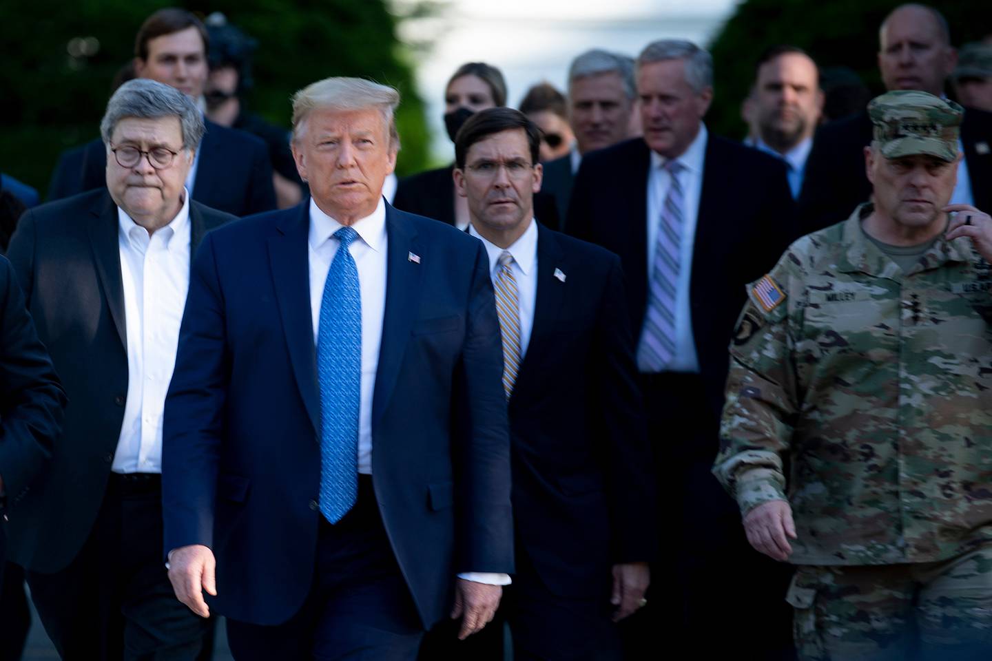 President Donald Trump walks with Attorney General William Barr, left, Secretary of Defense Mark Esper ,center, Chairman of the Joint Chiefs of Staff Gen. Mark A. Milley, right, and others from the White House to visit St. John's Church after the area was cleared of people protesting the death of George Floyd June 1, 2020, in Washington.