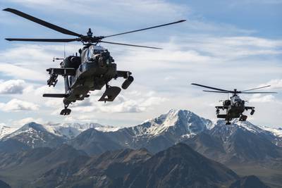 In this photo released by the Army, AH-64D Apache Longbow attack helicopters from the 1st Attack Battalion, 25th Aviation Regiment, fly over a mountain range near Fort Wainwright, Alaska, on June 3, 2019.