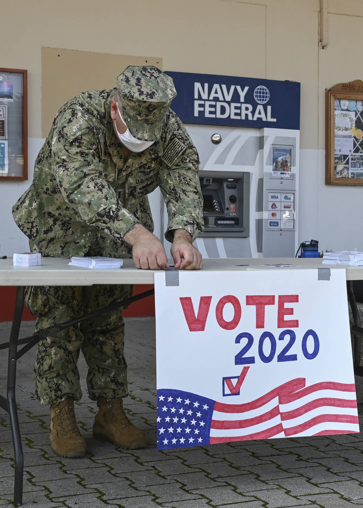 Naval Air Station Sigonella Voting Assistance Officer Lt. J.G. Timothy Martin sets up a voting booth in Italy in 2020.