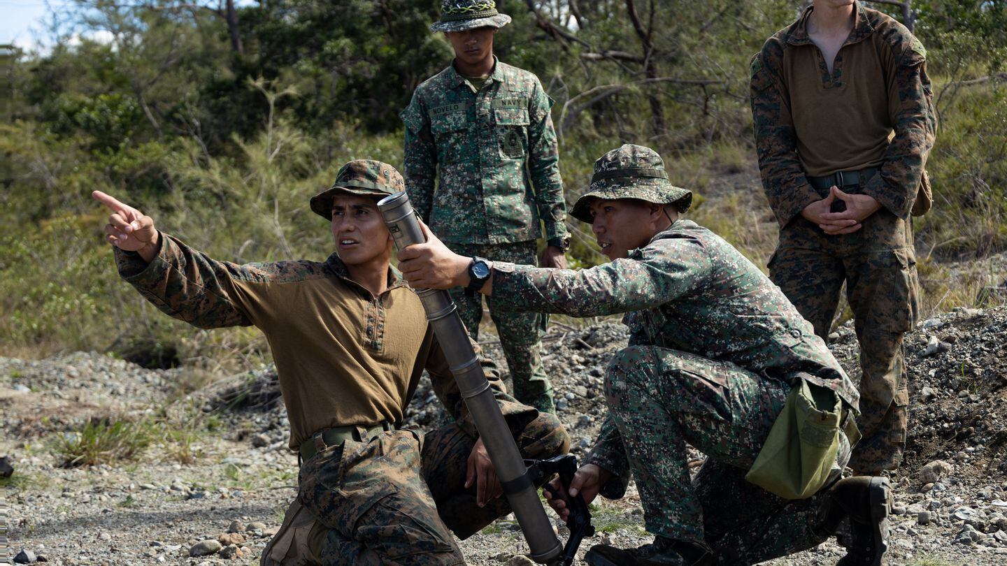 Mortarman Cpl. Renato Ortiz, left, familiarizes Philippine marine Sgt. Jomelan Marinas with an M224 60 mm mortar system at Paredes Air Station, Philippines, in 2023. (Sgt. Jacqueline C. Parsons/Marine Corps)