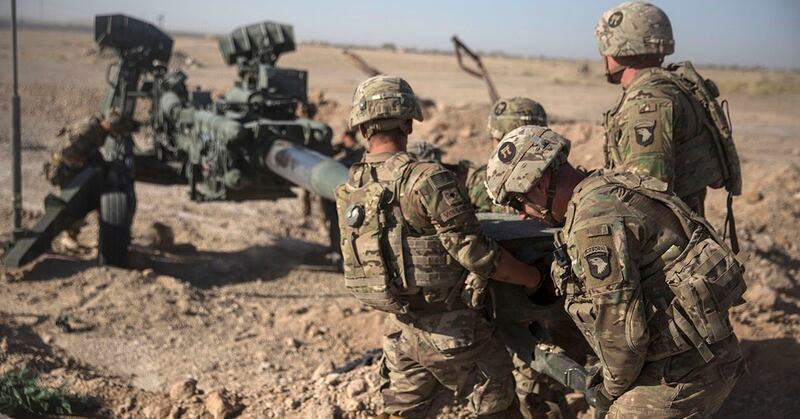 This June 10, 2017 photo provided by Operation Resolute Support, U.S. soldiers with Task Force Iron maneuver an M-777 howitzer, so it can be towed into position at Bost Airfield, Afghanistan. (Sgt. Justin T. Updegraf/Marine Corps via via AP)