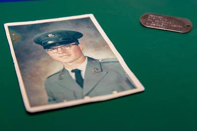 The ID tag of Vietnam War veteran and Purple Heart recipient Ron Hepper is pictured with his photo.