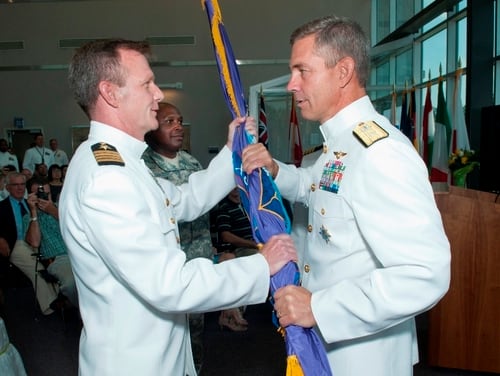 Retired Navy Capt. Jeffrey Breslau, left, pleaded guilty Tuesday to providing public affairs services to 