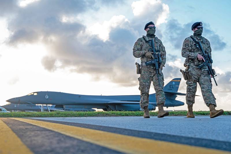 Security forces airmen patrol near a U.S. Air Force B-1B Lancer taxiway at Andersen Air Force Base, Guam, in support of a Bomber Task Force mission, Dec. 26, 2020.