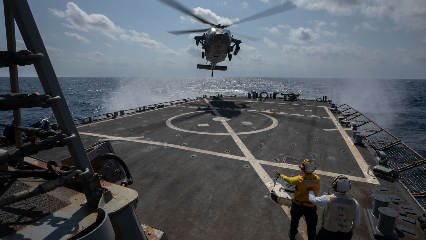 Sailors aboard the destroyer Laboon direct an MH-60S Sea Hawk helicopter onto the deck on Feb. 2, 2024, in the Red Sea. (Navy)