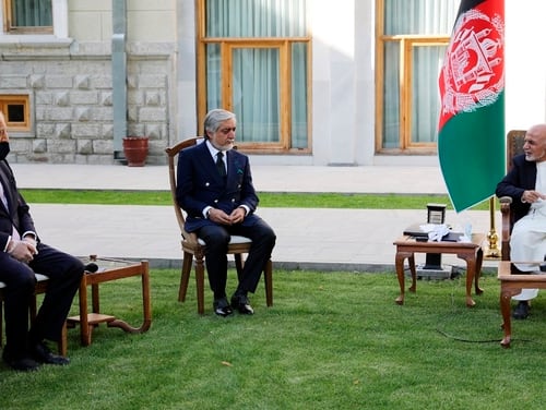 In this Wednesday, May 20, 2020, photo, Afghan President Ashraf Ghani, right, and fellow leader under a recently signed power-sharing agreement, Abdullah Abdullah, center, hold a meeting with U.S. peace envoy Zalmay Khalilzad aimed at resuscitating a U.S.-Taliban peace deal signed in February, at the Presidential Palace, in Kabul, Afghanistan. (The Presidential Palace via AP)