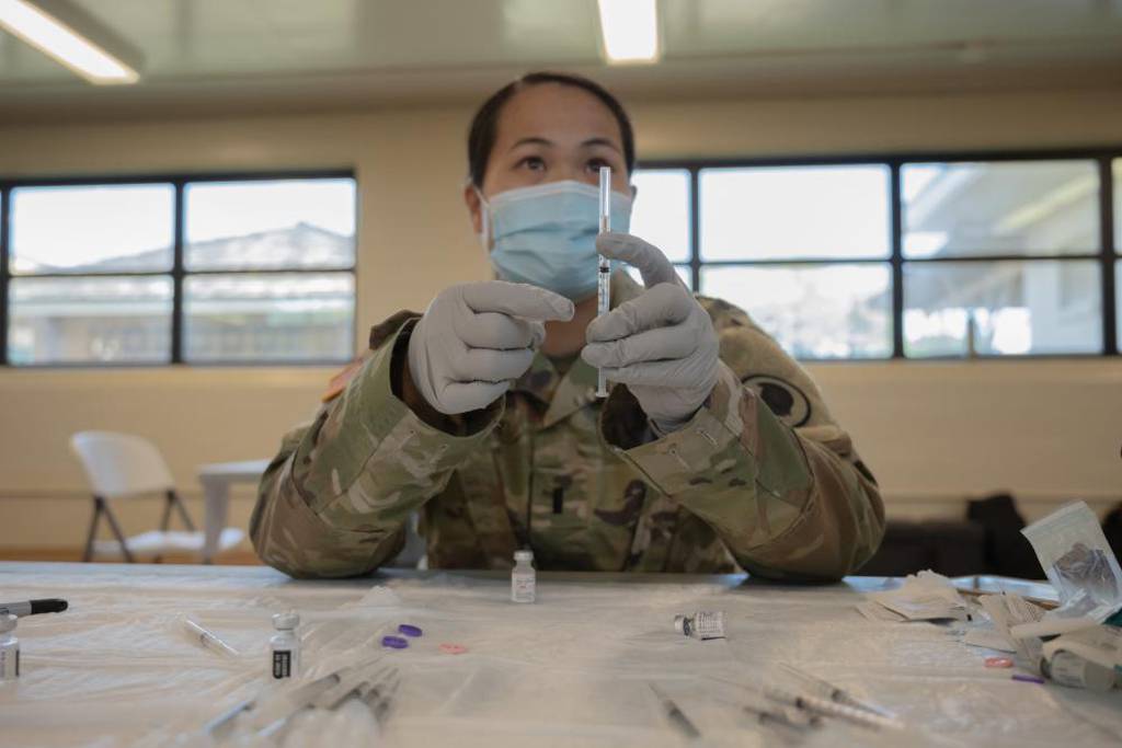 First Lt. Kitty Terry, a nurse from the Hawaii Army National Guard's medical detachment, displays a prepared syringe filled with Pfizer-BioNTech vaccine on Oct. 1, 2021, at the Hawaii Army Readiness Center, Kalaeloa, Hawaii. (1st Lt. Anyah Peatross/Army National Guard)