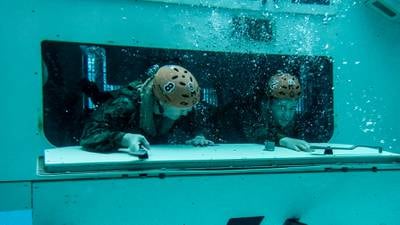 Assault Amphibian School students take a ride in the Submerged Vehicle Egress Trainer