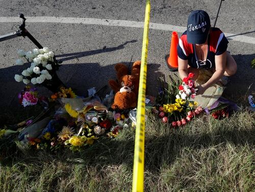 Rebecca Thompson places flowers at a makeshift memorial near the scene of a shooting at the First Baptist Church of Sutherland Springs to honor victims Nov. 6 in Sutherland Springs, Texas. (Eric Gay/AP)