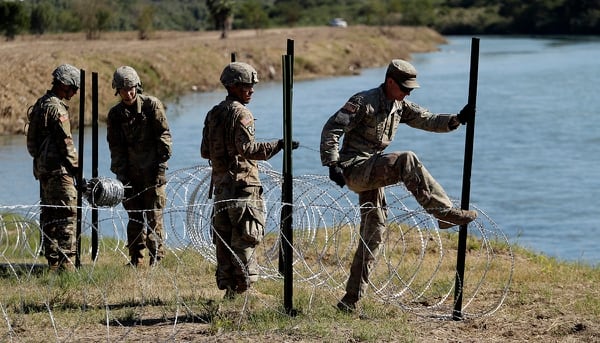 Members of the U.S. military install multiple tiers of concertina wire along the banks of the Rio Grande near the Juarez-Lincoln Bridge at the U.S.-Mexico border, Friday, Nov. 16, 2018, in Laredo, Texas. (Eric Gay/AP)
