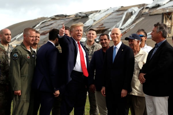 President Donald Trump speaks with base and political officials May 8 as he tours areas of Tyndall Air Force Base, Fla., that were damaged by Hurricane Michael. (Evan Vucci/AP)