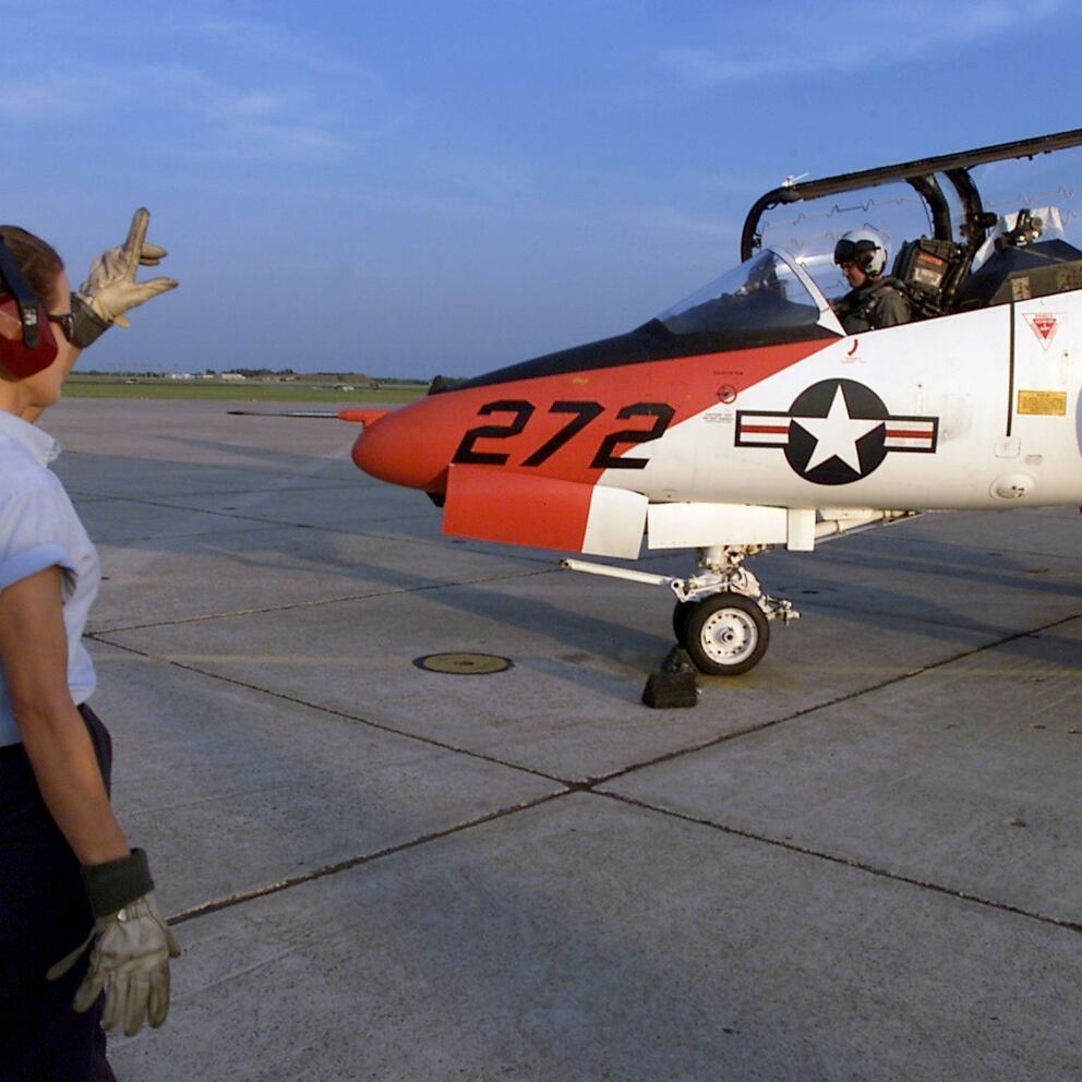 In this April 24, 2002, photo, flight instructor Capt. William Cupples, front seat, and Ensign Kristin Burke begin their flight in a T-45 aircraft at Naval Air Station Kingsville in Kingsville, Texas. The base was evacuating as many of the trainer jets as possible ahead of Hurricane Harvey. (Corpus Christi Caller-Times via AP)
