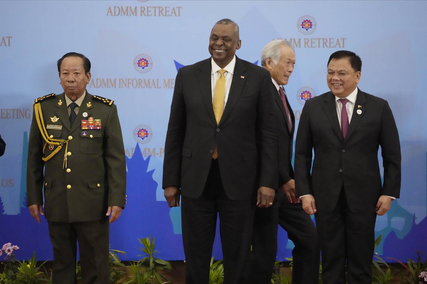 U.S. Secretary of Defense Lloyd J. Austin III, center, poses for a group photo together with Cambodia's Defense Minister Tea Banh, left, Philippines Senior Undersecretary Jose Faustino Jr., right, as Singapore Defense Minister Ng Eng Hen walks at the venue of the Association of Southeast Asian Nations (ASEAN) during the ASEAN-United State Defense Ministers' Informal Meeting in Siem Reap, Cambodia, Tuesday, Nov. 22, 2022.