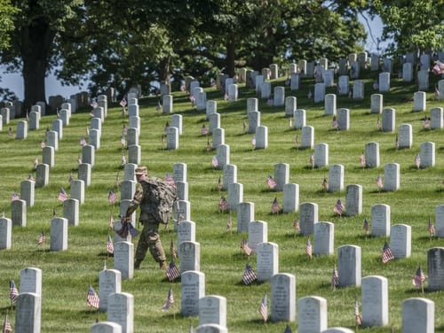 Soldiers from the 3d U.S. Infantry Regiment (The Old Guard) place U.S. flags at headstones in Section 38 during the Flags In event at Arlington National Cemetery in Virginia on May 24, 2018. (Elizabeth Fraser/Arlington National Cemetery)