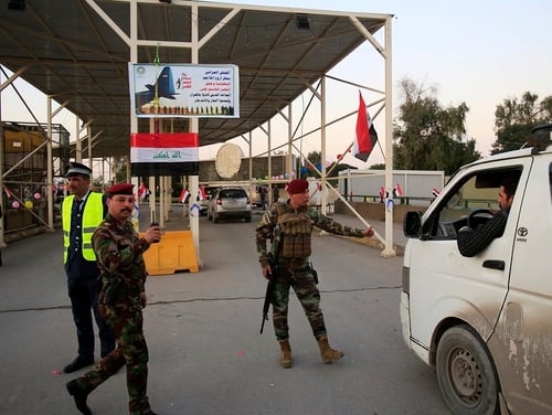 Iraqi security forces stand guard as they check motorists entering the so-called Green Zone in Baghdad, Iraq, on Dec. 10, 2018. Iraq celebrated the anniversary of its costly victory over the Islamic State group, which has lost virtually all the territory it once held but still carries out sporadic attacks. (Karim Kadim/AP)