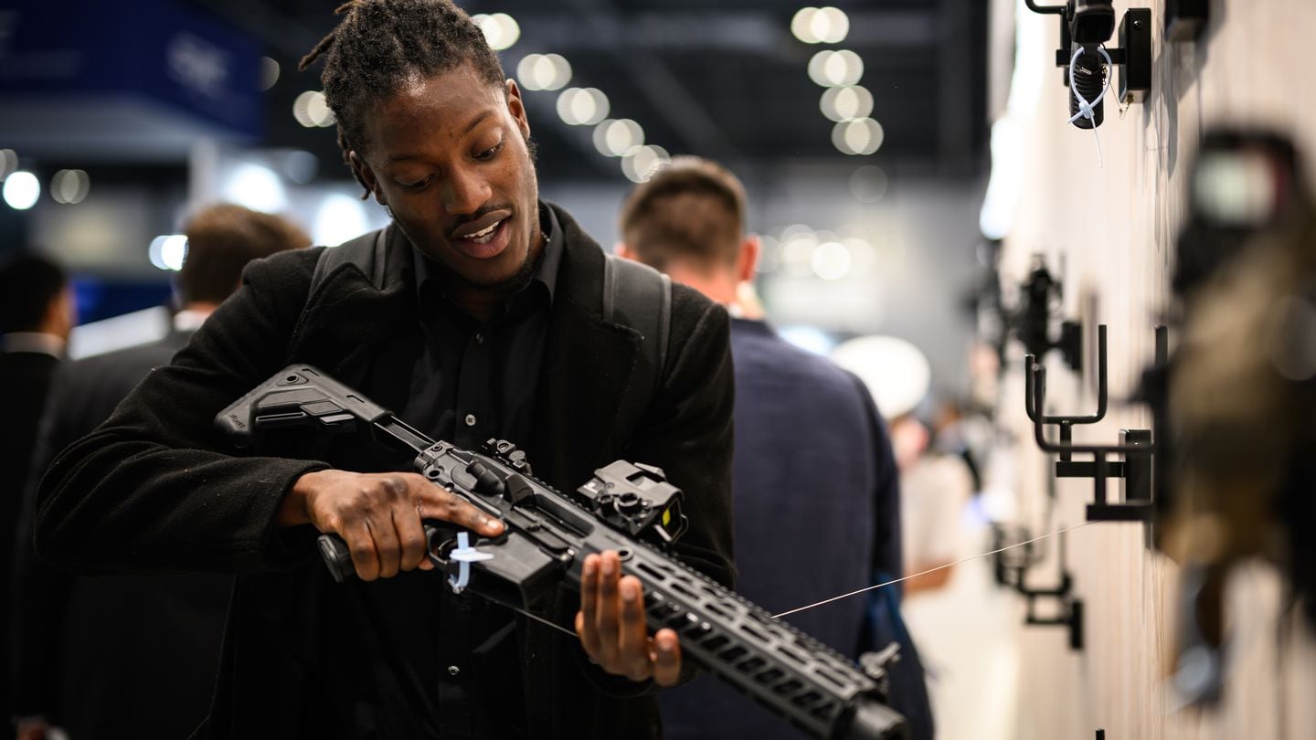 A visitor of the DSEI show looks at a Sig Sauer MCX firearm on Sept. 12, 2023, in London. (Leon Neal/Getty Images)
