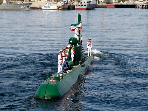 Members of Iran's navy stand on the Ghadir-942 submarine in southern port of Bandar Abbas, Iran, at the mouth of the strategic Strait of Hormuz, Thursday, Nov. 29, 2018. Iran's navy has acquired two new mini submarines designed for operations in shallow waters such as the Persian Gulf, the Iranian state TV reported on Thursday. (Rahbar Emamdadi/Mehr News Agency via AP)