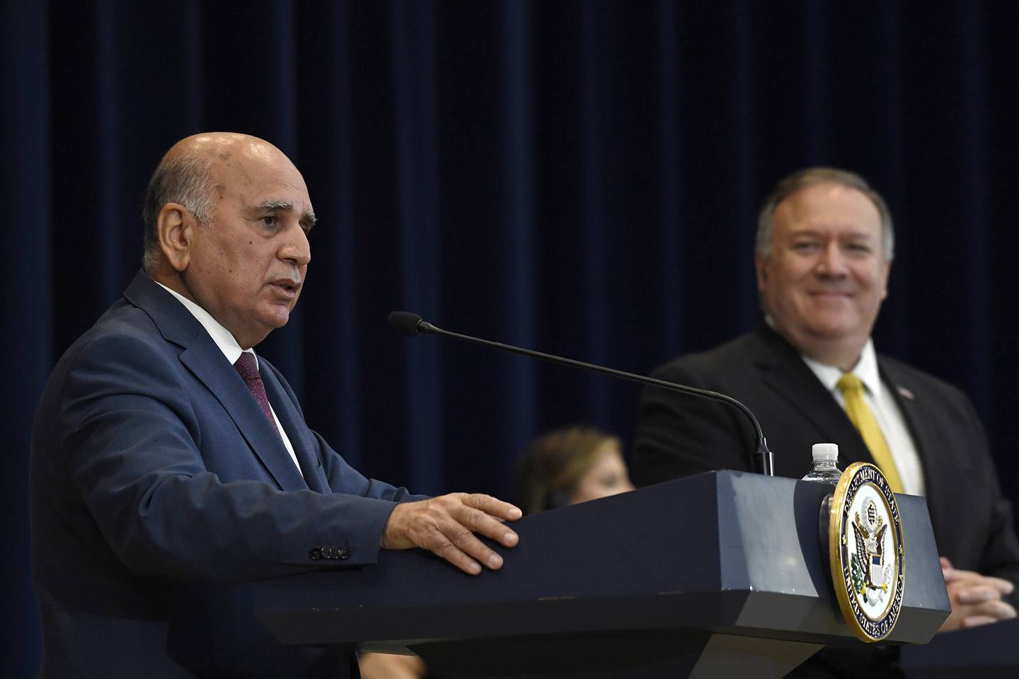 Iraqi Foreign Minister Fuad Hussein, left, speaks at the State Department in Washington, Wednesday, Aug. 19, 2020, during a news conference with Secretary of State Mike Pompeo, right.