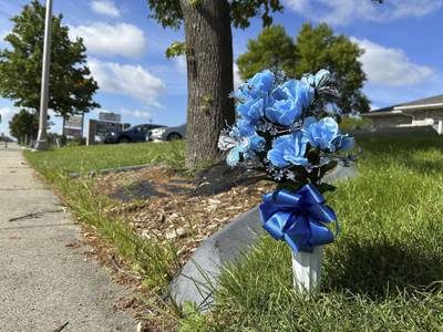 Flowers rest near the scene, Saturday, July 15, 2023, in Fargo, N.D., where one police officer was fatally shot and two others were critically wounded Friday, July 14.