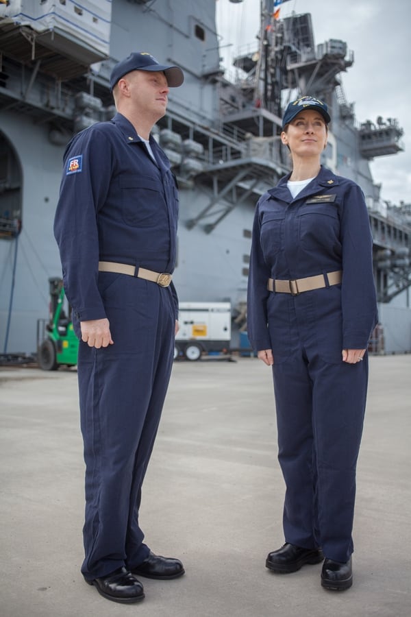 Naval Station Norfolk (Jan 13, 2017 -- The amphibious assault ship Kearsarge stands as the backdrop for Lt. Cmdr. Ken Gilmore (L) and Lt. Cmdr. Heather Flores Fleet Forces Command wearing the approved version of the Improved Fire Retardant Variant Coverall that FFC announced this week. The new coveralls are expected to make their fleet debut in late fall, 2017 and could be adopted into the seabag in the future. Photo by Mark D. Faram/staff