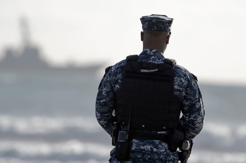 151116-N-AV746-066 PACIFIC OCEAN (Nov. 16, 2015) Master-At-Arms 3rd Class Anthony Dodson, from Palmdale, California, stands watch as the guided-missile destroyer USS Stockdale (DDG 106) sits anchored off the southern coast of California. (U.S. Navy photo by Mass Communication Specialist 2nd Class Timothy M. Black/Released)