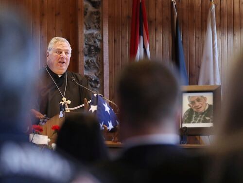 Friar Stephen Ziton officiates the funeral service for WWII Marine veteran Cpl. Remigio 