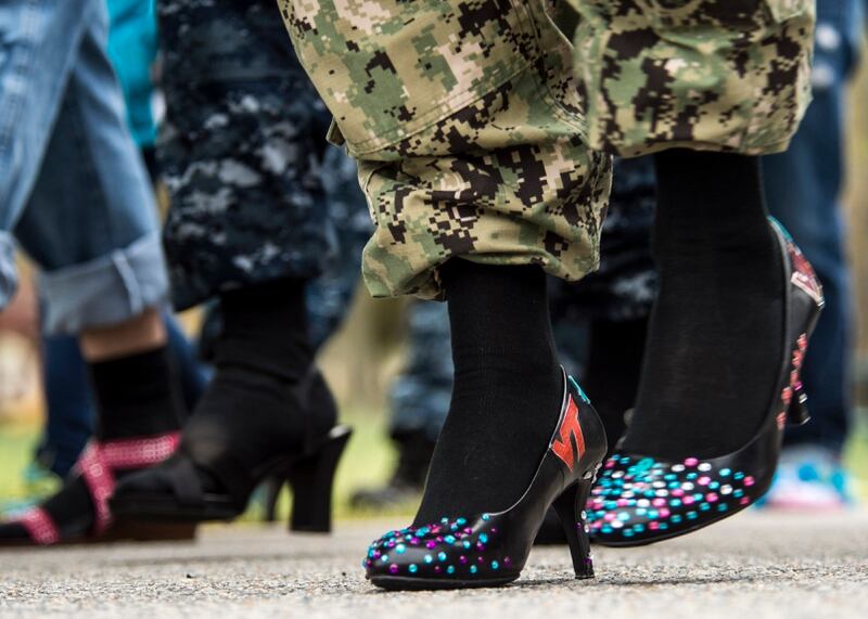 Joint Expeditionary Base Little Creek-Fort Story service members, families, and friends walk a mile in heels during the annual Walk a Mile in Her Shoes event. Walk a Mile in Her Shoes is an opportunity for men and women to raise awareness in their community about rape, sexual assault and gender violence. (U.S. Navy photo by Mass Communication Specialist 3rd Class Andrew Schneider/Released)