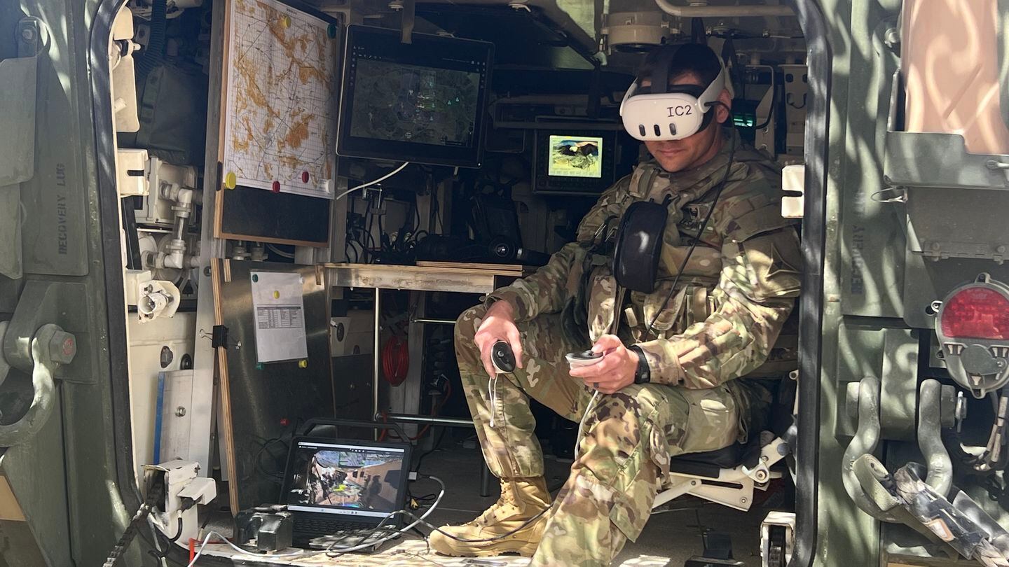 A soldier at Project Convergence demonstrates the use of an augmented reality headset to identify a threat and call for fires. (Jen Judson/Staff)