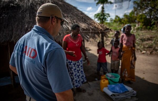 A single mother of four who lost part of her home during Cyclone Idai receives a shelter kit from World Vision and U.S. Agency for International Development in Nhamatanda, Mozambique, April 9. (Tech. Sgt. Chris Hibben/Air Force)