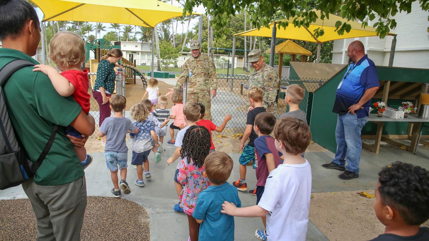 Children, parents and staff enter the new CDC playground on Army Garrison-Kwajalein Atoll during the facility's opening in April 2022. (Jessica Dambruch/Army)