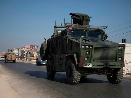 A Turkish army convoy drives along the Bab al-Hawa highway on Aug. 24, 2019, on its way to reinforce a Turkish military observation point in northwestern Syria. (Aaref Watad/AFP via Getty Images)